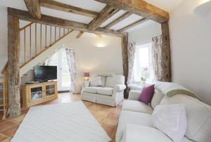 a living room with a white couch and a tv at 1 Bed in Wickham Market oc-samp in Wickham Market