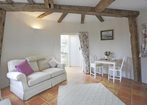 a living room with a couch and a table at 1 Bed in Wickham Market oc-samp in Wickham Market