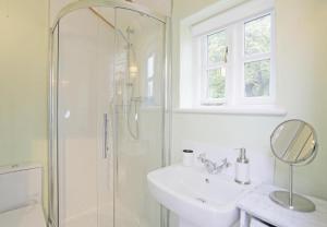 a white bathroom with a sink and a shower at 1 Bed in Wickham Market oc-samp in Wickham Market +10 photos
