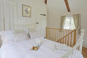a white bed with a tray of food on it at 1 Bed in Wickham Market oc-samp in Wickham Market