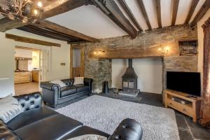 a living room with a couch and a fireplace at 3 Bed in Tywyn oc-bow248 in Abergynolwyn