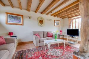 a living room with a couch and a tv at 2 Bed in Erpingham oc-2278 in Erpingham