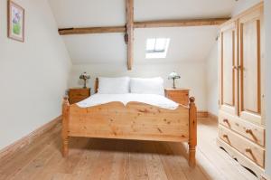 a bedroom with a wooden bed and two night stands at 2 Bed in Erpingham oc-2278 in Erpingham