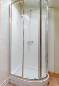 a shower with a glass door in a bathroom at 2 Bed in Erpingham oc-2278 in Erpingham