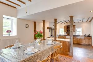 a kitchen with a large island with a table and chairs at 3 Bed in Tywyn oc-bow248 in Abergynolwyn