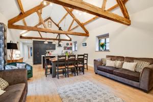 a dining room and living room with wooden beams at 4 Bed in Dinas Mawddwy oc-bow305 in Aber Cowarch