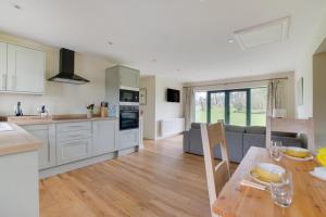 a kitchen and living room with a table and a couch at 2 Bed in Weybread oc-tclwey in Needham +6 photos