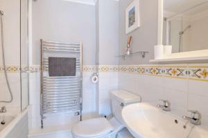a white bathroom with a toilet and a sink at 4 Bed in Southwold oc-hsumme in Reydon +12 photos