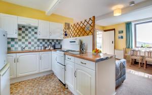 a kitchen with white appliances and a dining room at 2 Bed in Berwick-upon-Tweed oc-nb678 in Lowick