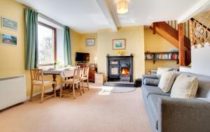 a living room with a couch and a table and a fireplace at 2 Bed in Berwick-upon-Tweed oc-nb678 in Lowick