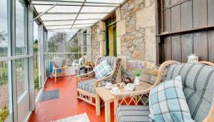 a patio with chairs and a table and windows at 2 Bed in Berwick-upon-Tweed oc-nb678 in Lowick