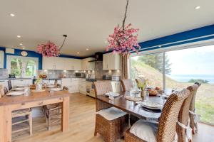 a kitchen with a wooden table and chairs at 6 Bed in Barmouth oc-bow245 in Fairbourne