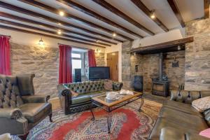 a living room with a couch and a fireplace at 6 Bed in Barmouth oc-bow245 in Fairbourne