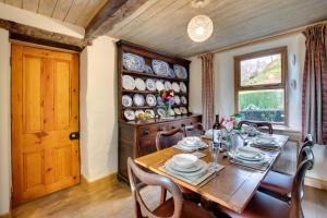 a dining room with a table and chairs and a window at 3 Bed in Dolgellau oc-wah464 in Llanfachreth +11 photos