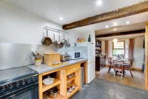 a kitchen with a stove and a dining room with a table at 3 Bed in Dolgellau oc-wah464 in Llanfachreth