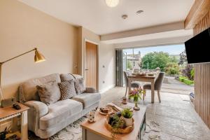 a living room with a couch and a table at 1 Bed in Askrigg oc-c33109 in Askrigg