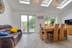 a living room with a table and a couch at 3 Bed in Llanfynydd oc-pw9215 in Llanfynydd