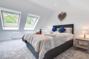 a bedroom with a large bed with blue pillows at 3 Bed in Llanfynydd oc-pw9215 in Llanfynydd