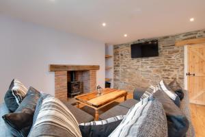 a living room with a couch and a fireplace at 2 Bed in Tregaron oc-bow289 in Tregaron