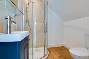 a bathroom with a shower and a sink and a toilet at 3 Bed in Llanfynydd oc-pw9215 in Llanfynydd +10 photos