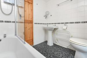 a bathroom with a toilet and a sink and a shower at 2 Bed in Nefyn oc-tynixs in Nefyn +7 photos