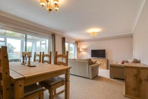 a living room with a wooden table and a couch at 2 Bed in Port Eynon oc-hh2104 in Port-Eynon