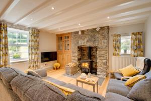 a living room with a couch and a stone fireplace at 2 Bed in Dinas Mawddwy oc-bow268 in Machynlleth