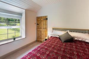 a bedroom with a bed and a window at 2 Bed in Dinas Mawddwy oc-bow268 in Machynlleth