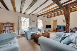 a living room with two couches and a tv at 4 Bed in Saxmundham oc-oth in Dunwich
