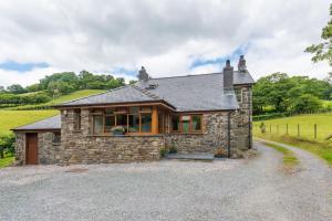 a small stone house with a gravel driveway at 2 Bed in Dinas Mawddwy oc-bow268 in Machynlleth