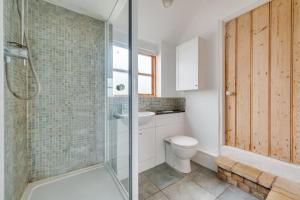 a bathroom with a toilet and a glass shower at 4 Bed in Saxmundham oc-oth in Dunwich +5 photos