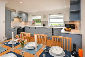 a kitchen with a table with chairs and a dining room at 2 Bed in Abersoch oc-147cae in Abersoch