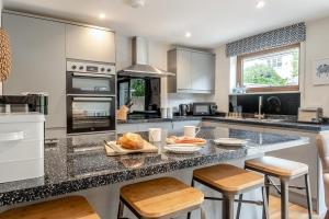 a kitchen with a large island with bar stools at 3 Bed in Aldeburgh oc-16afaw in Aldeburgh