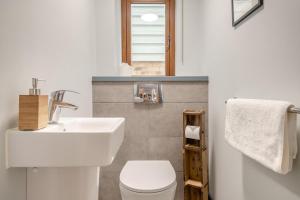 a bathroom with a white sink and a toilet at 3 Bed in Aldeburgh oc-16afaw in Aldeburgh +14 photos