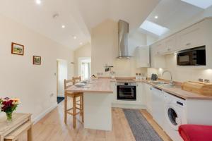 a kitchen with white cabinets and a counter top at 1 Bed in Llanrwst oc-wag696 in Llanrwst