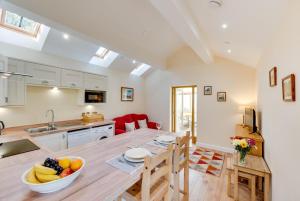 a kitchen with a table with a bowl of fruit on it at 1 Bed in Llanrwst oc-wag696 in Llanrwst
