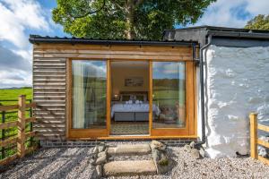a tiny house with a large glass window at 1 Bed in Llanrwst oc-wag696 in Llanrwst +8 photos