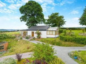 a cottage in the middle of a garden at 1 Bed in Llanrwst oc-wag696 in Llanrwst