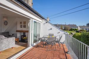 a patio with a table and chairs on a balcony at 2 Bed in Abersoch oc-23caed in Abersoch