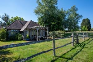 a fence in front of a house with a gazebo at 2 Bed in Beckley oc-rh1116 in Beckley