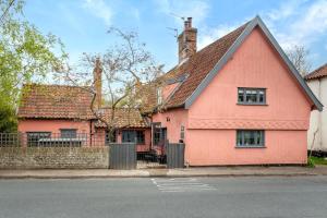 a pink house on the side of a street at 2 Bed in Bramfield oc-cobb in Bramfield +5 photos