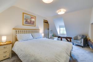a bedroom with a large bed and a chair at 2 Bed in Bramfield oc-cobb in Bramfield
