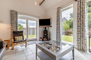 a living room with a large window and a tv at 4 Bed in Slindon oc-t29883 in Eccleshall