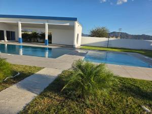 a swimming pool in front of a house at Luana's 0601 in Choluteca
