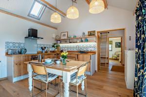 a kitchen and dining room with a table and chairs at 1 Bed in Builth Wells oc-p27441 in Builth Road