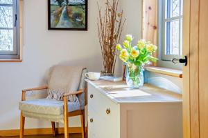 a vase of flowers on a counter with a chair at 1 Bed in Builth Wells oc-p27441 in Builth Road