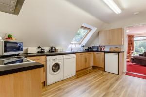 a kitchen with a washer and dryer in it at 2 Bed in Woodbridge oc-vav in Hollesley +21 photos
