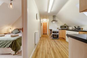 a kitchen and a bedroom with a bed in a room at 2 Bed in Woodbridge oc-vav in Hollesley