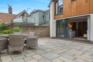 a patio with a table and chairs and a house at 7 Bed in Aldeburgh oc-midba in Aldeburgh