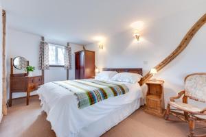 a bedroom with a large white bed and a chair at 2 Bed in Biddenden oc-cb559 in Biddenden